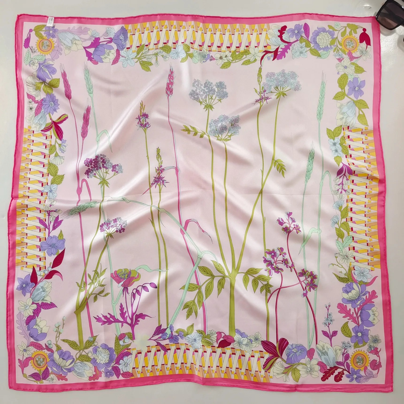 Pink printed silk twill scarf styled as a premium fashion accessory