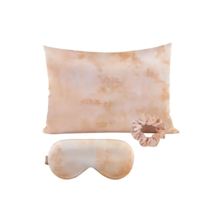 A custom DOCSUN satin silk sleep set featuring a tie-dye print pillowcase, a matching eye mask, and a scrunchie, isolated on a white background.