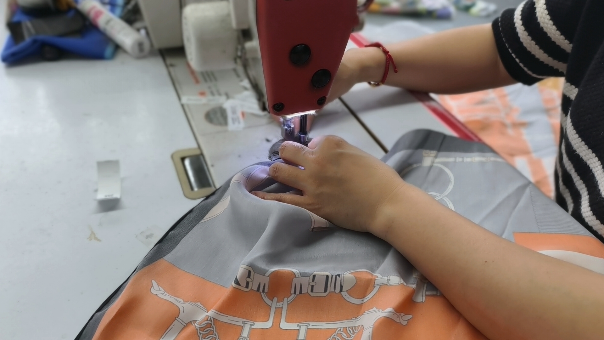 Silk scarf edge being sewn during custom scarf production