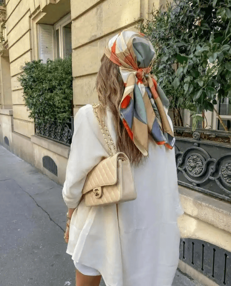 Woman wearing a structured printed silk twill scarf around the neck
