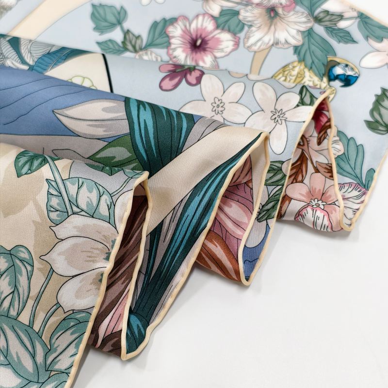 Close-up of a rounded hand-rolled hem on a custom silk scarf