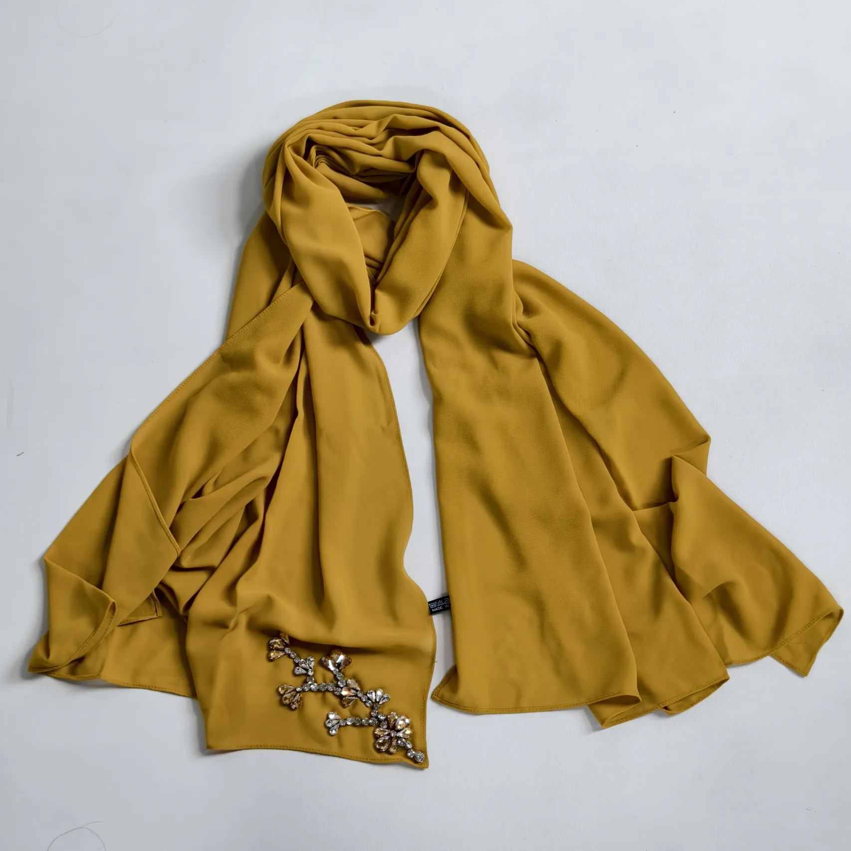 Woman wearing silk chiffon scarf as a versatile sustainable fashion accessory
