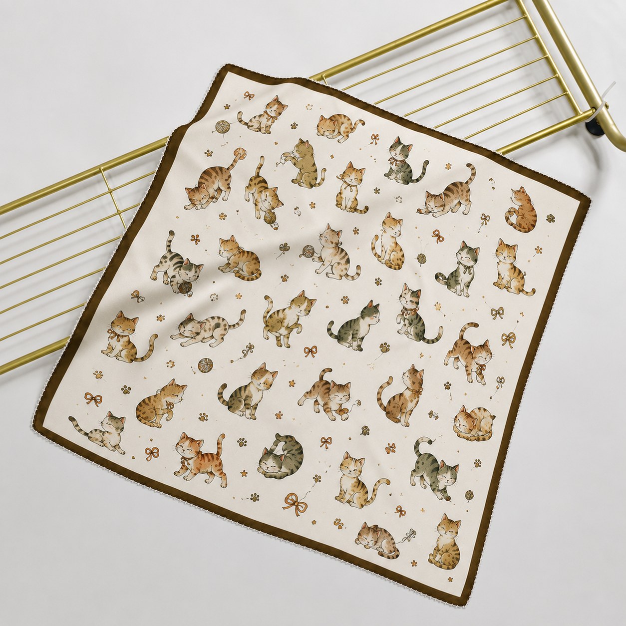 Ivory mulberry silk scarf laid flat with cartoon kitten motifs
