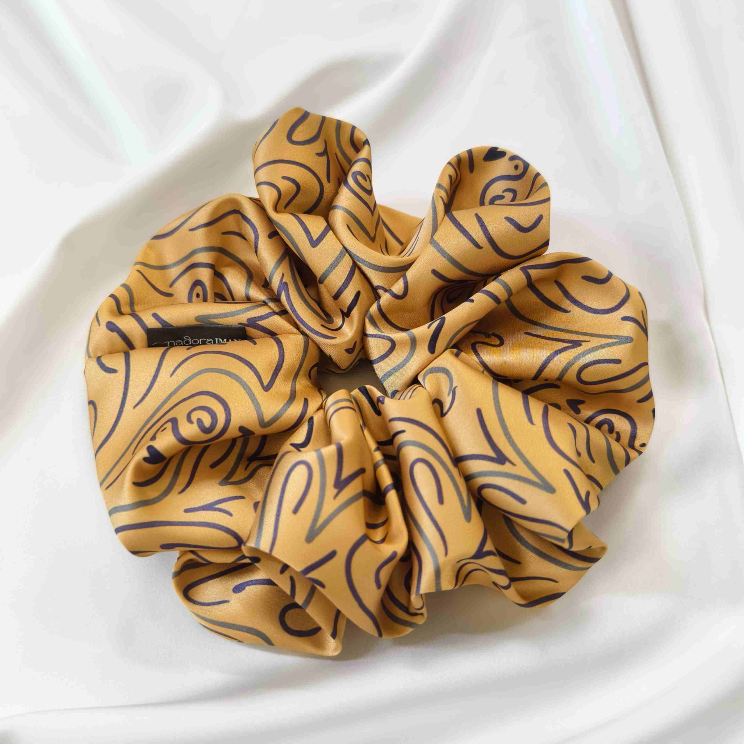 Satin silk scrunchies showing fabric sheen and stitching