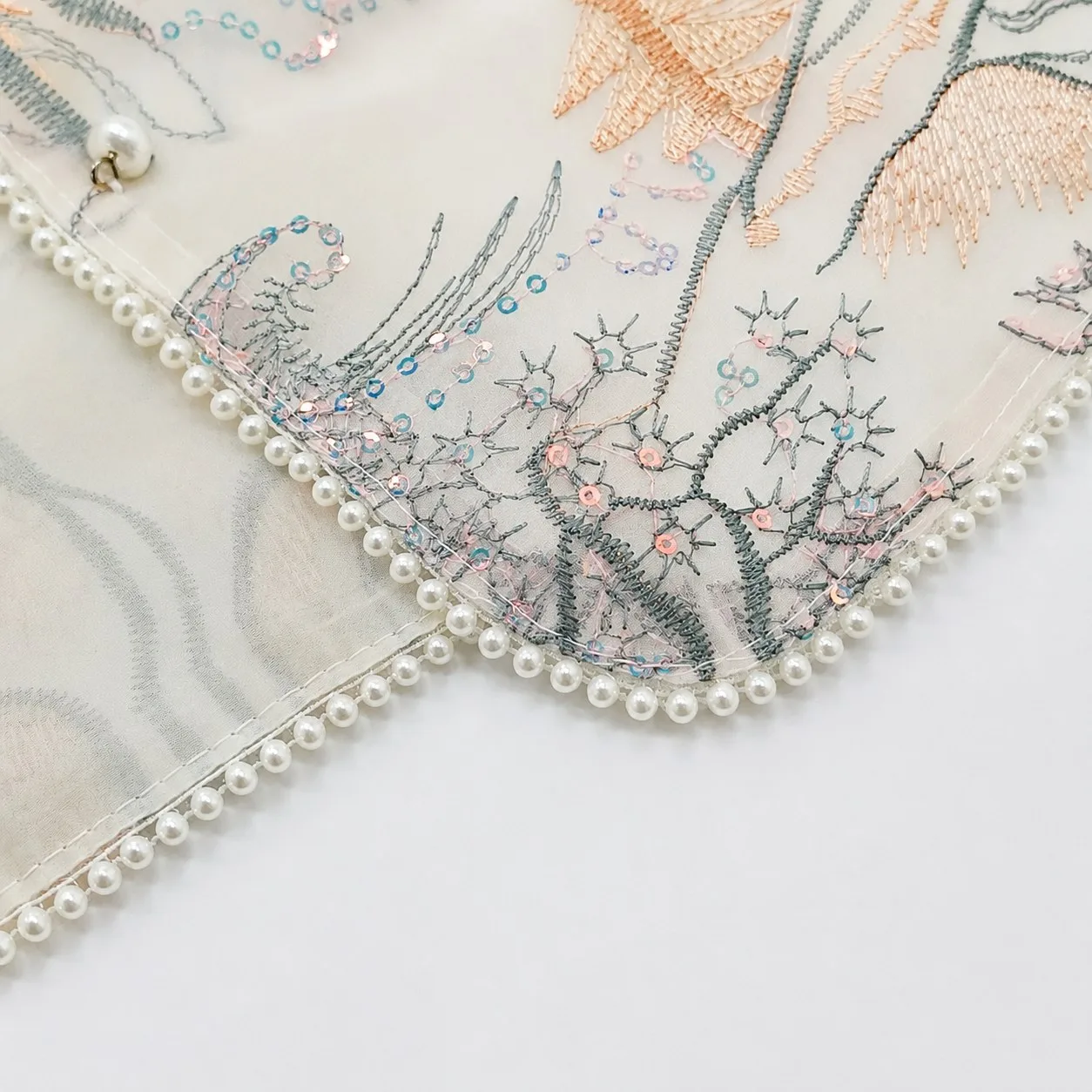 Decorative beaded edge craftsmanship on a custom scarf