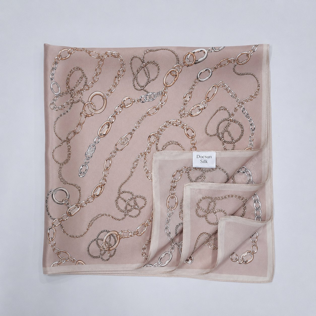 Chain print silk scarf styled with orange accessory for brand scarf collection planning
