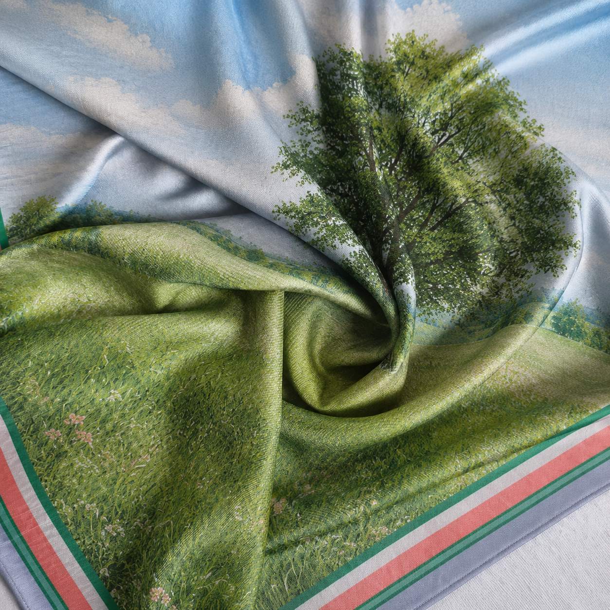Tree motif print detail on a custom branded silk scarf