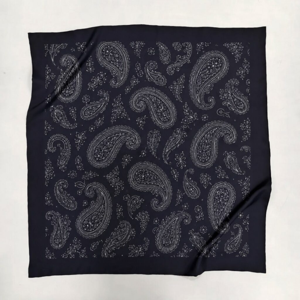 Dark navy-black mulberry silk scarf with silver-gray paisley prints, featuring a smooth texture and natural silk sheen.