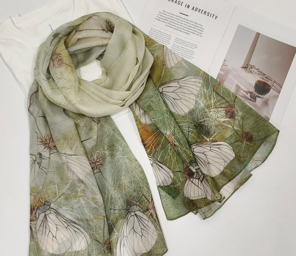Green butterfly print mulberry silk long scarf styled with a white top for a soft and elegant look