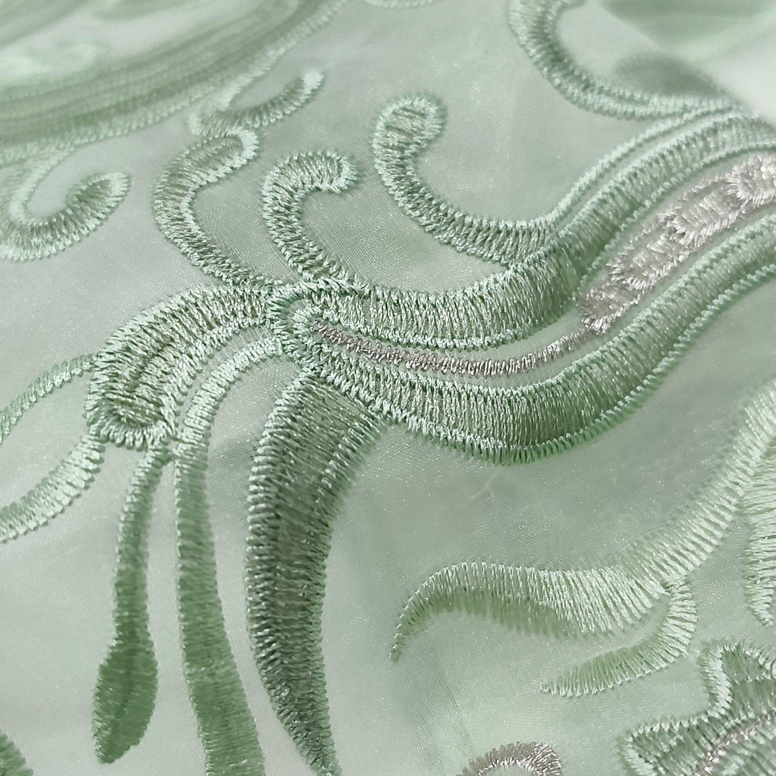Fine embroidery craftsmanship applied to scarf fabric