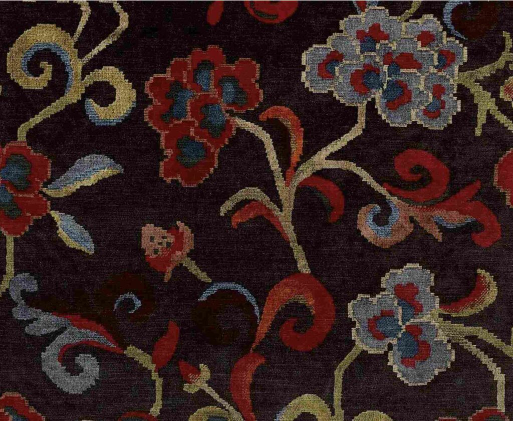 A dark floral vine fabric pattern with red, blue-gray, and gold botanical motifs arranged in a vintage decorative style.