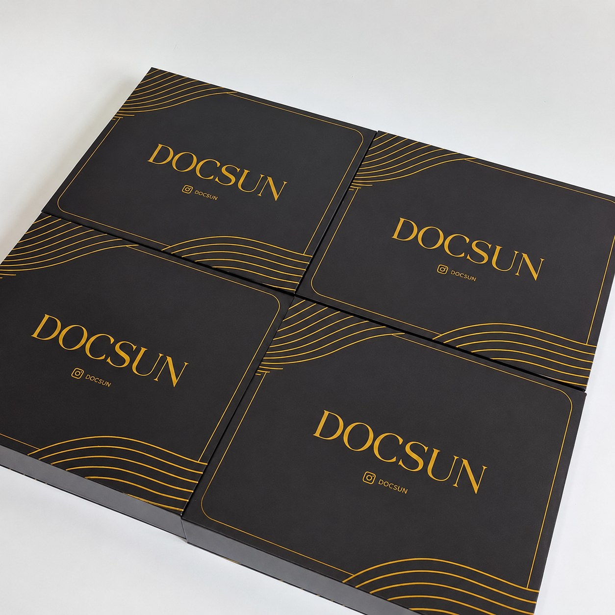 Gold border line detail on custom black gift box packaging