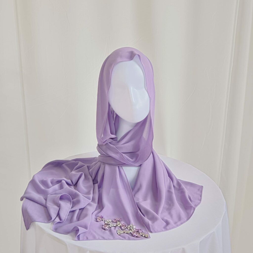 purple chiffon scarf styled as a headscarf with soft drape and pink rhinestone floral branch embellishment.