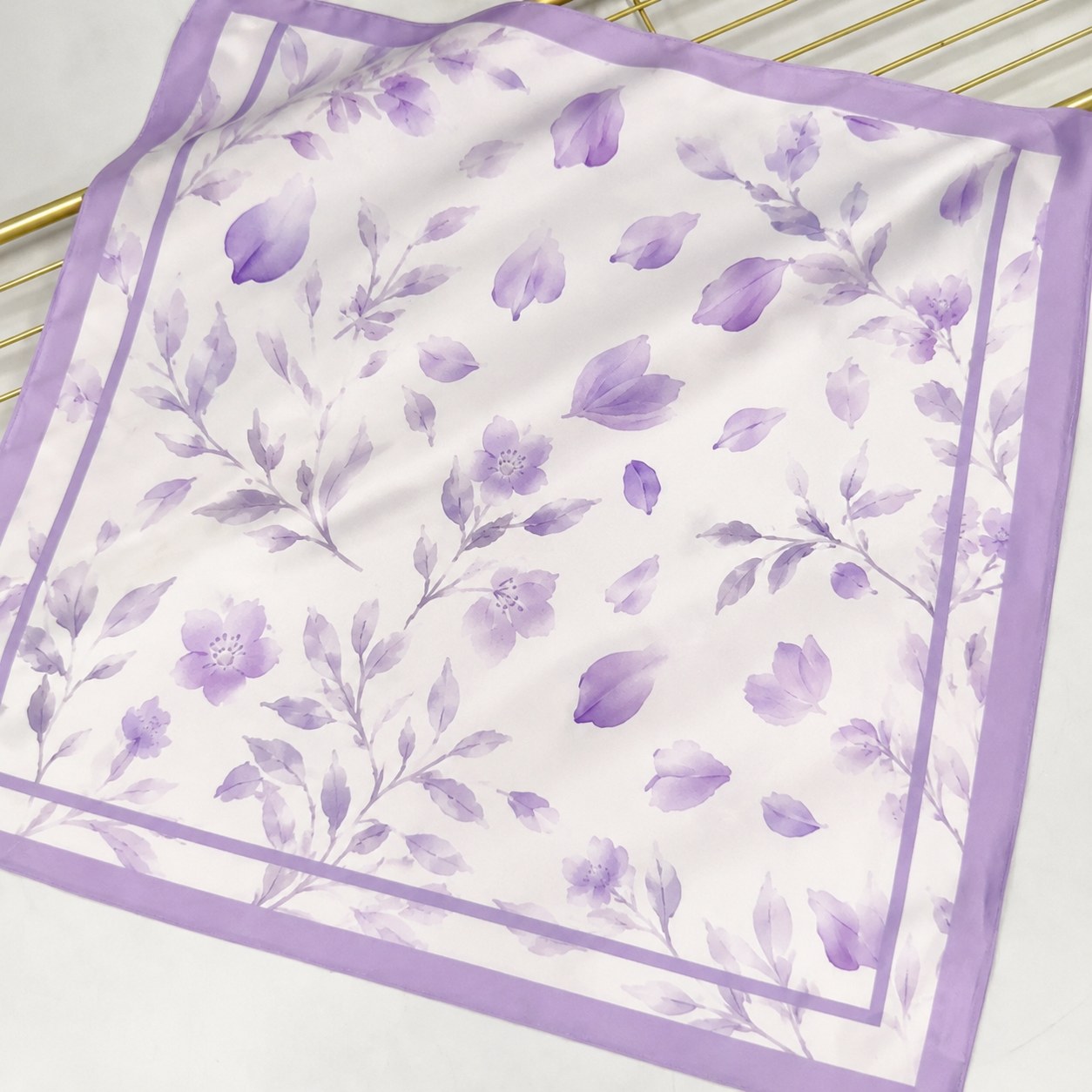 Leaf pattern silk scarf styled as a small square fashion accessory