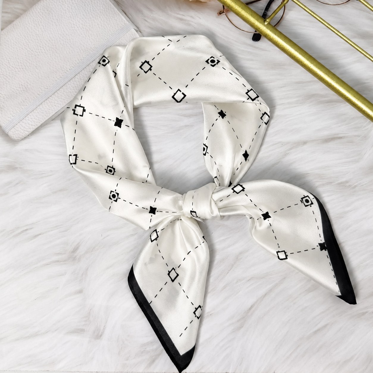 Mulberry silk scarf with ivory base and black border showing refined sustainable accessory design