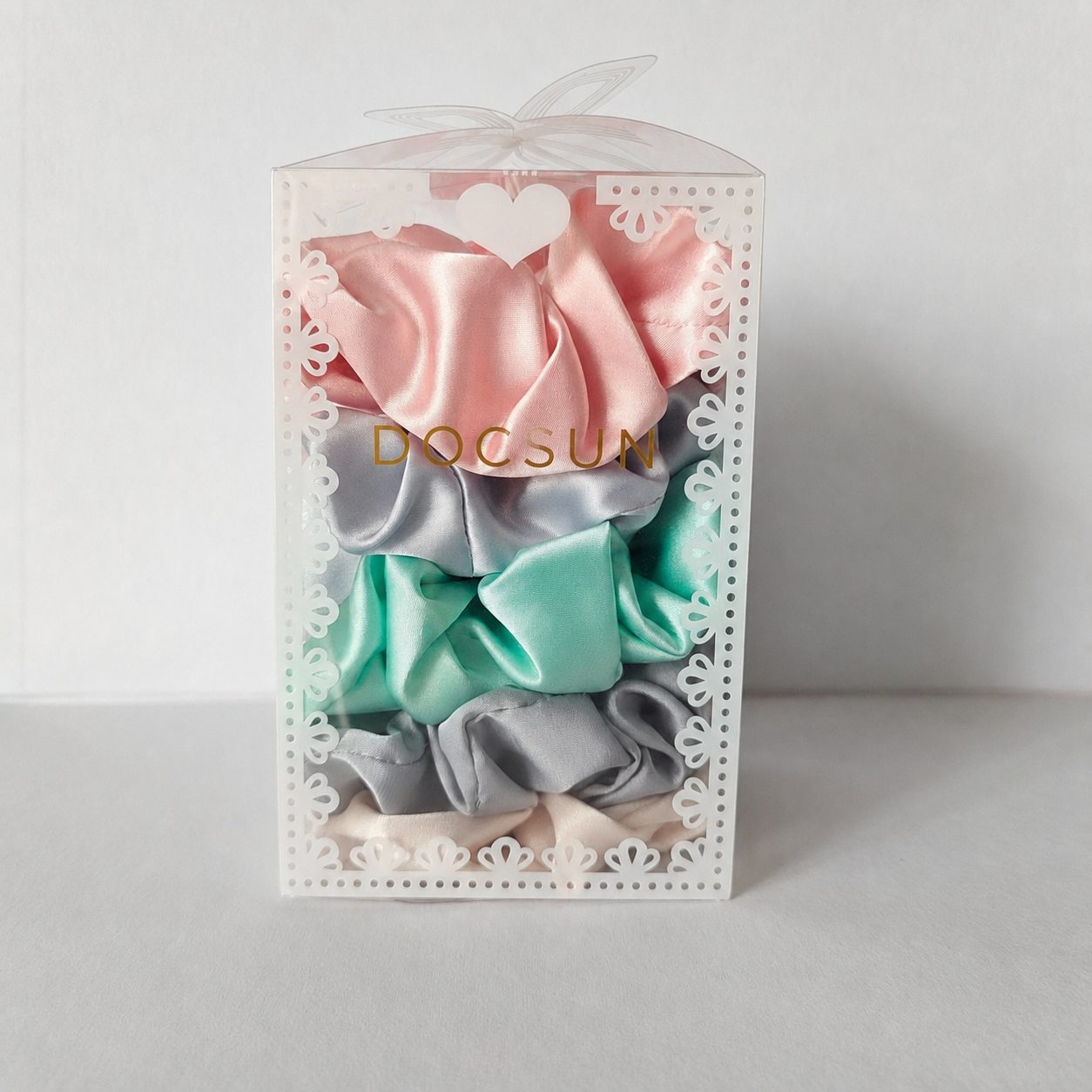 Pink retail box containing assorted mulberry silk scrunchies
