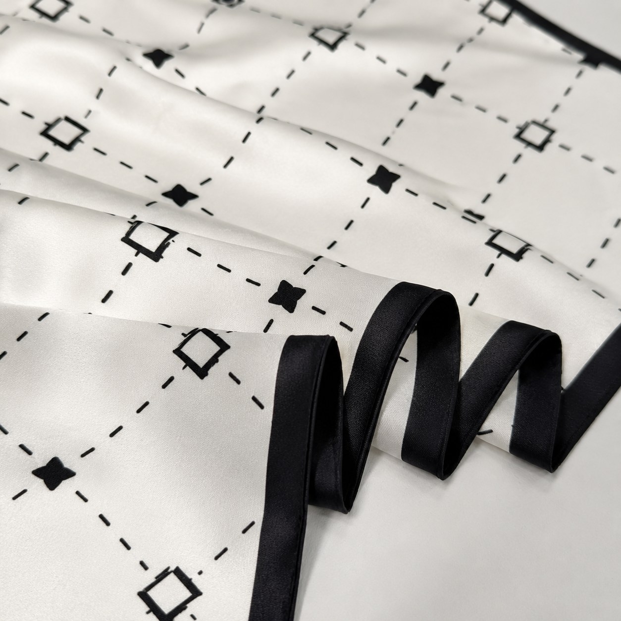 Silk scarf with ivory base and black border for eco-friendly custom printed scarf design